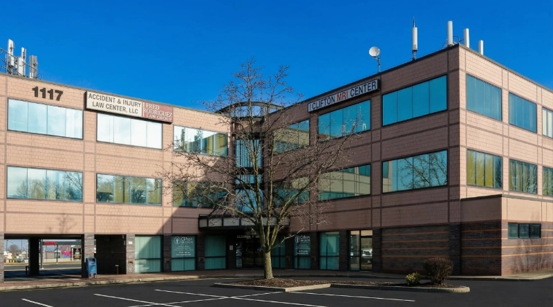 Exterior view Vein Treatment Clinic a modern medical office building under a clear blue sky.