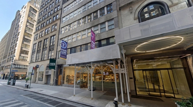 Exterior view Vein Treatment Clinic a modern medical office building under a clear blue sky.