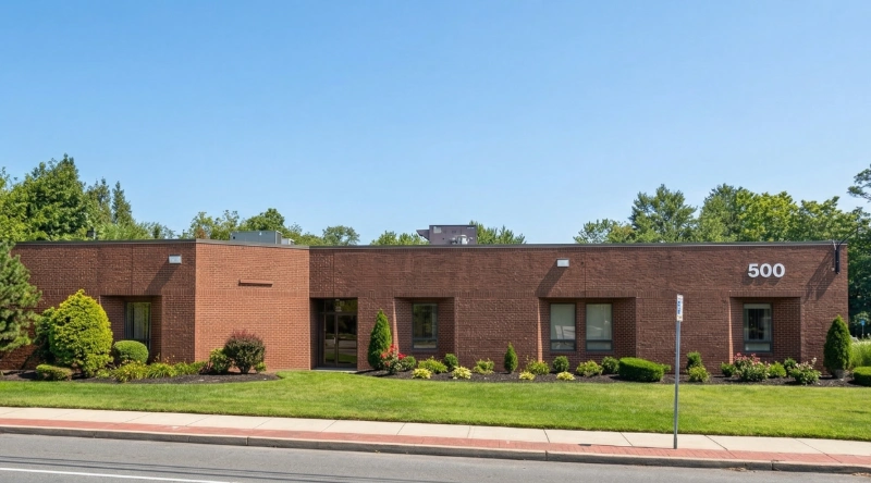 Exterior view Vein Treatment Clinic a modern medical office building under a clear blue sky.
