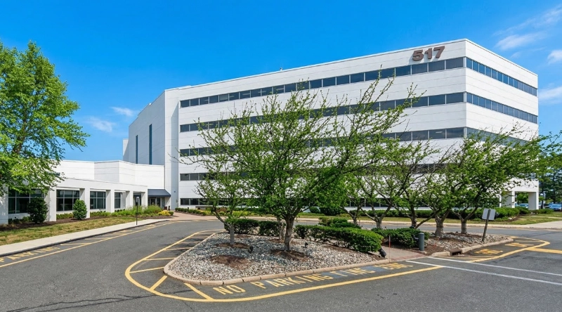 Exterior view Vein Treatment Clinic a modern medical office building under a clear blue sky.