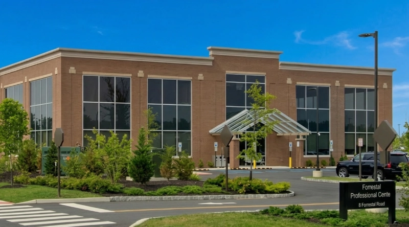 Exterior view Vein Treatment Clinic a modern medical office building under a clear blue sky.
