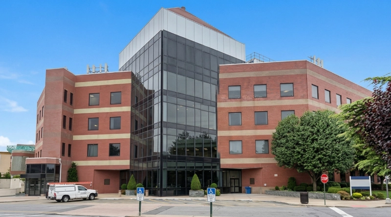 Exterior view Vein Treatment Clinic a modern medical office building under a clear blue sky.
