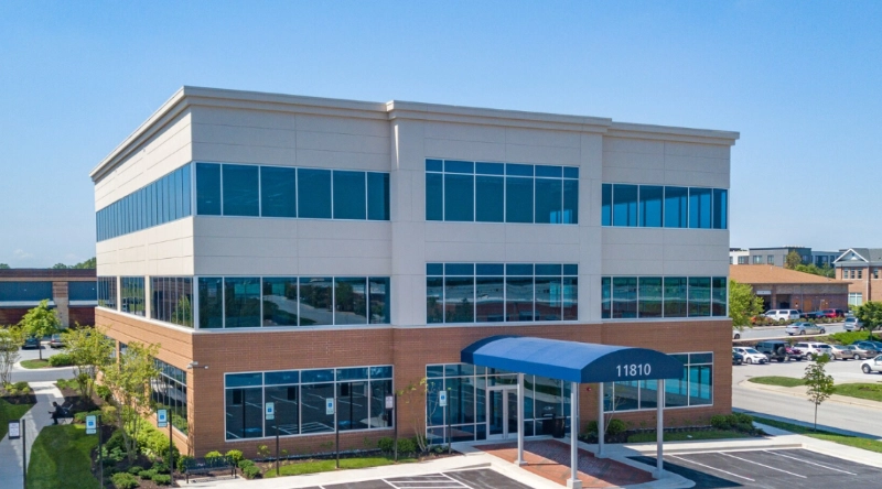 Exterior view Vein Treatment Clinic a modern medical office building under a clear blue sky.