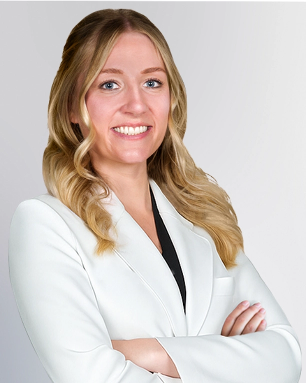 A professional portrait of a Physician Assistant at Vein Treatment Clinic. She is wearing a white medical coat and standing with her arms crossed, representing the expert and compassionate clinical team dedicated to patient care and pain relief.
