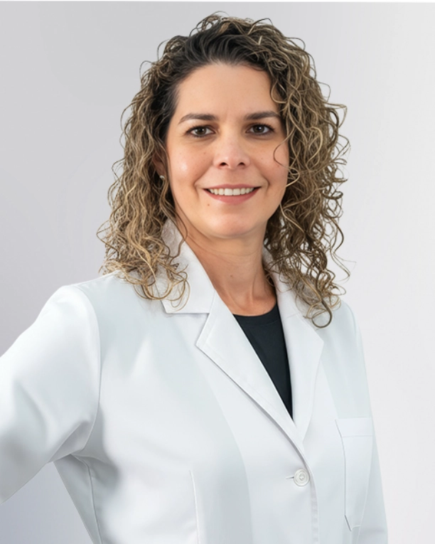 A professional portrait of a Physician Assistant at Vein Treatment Clinic. She is wearing a white medical coat and standing with her arms crossed, representing the expert and compassionate clinical team dedicated to patient care and pain relief.