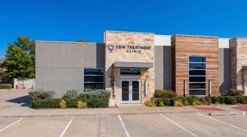 Exterior view Vein Treatment Clinic a modern medical office building under a clear blue sky.