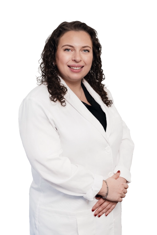 A professional portrait of a Physician Assistant at Vein Treatment Clinic. She is wearing a white medical coat and standing with her arms crossed, representing the expert and compassionate clinical team dedicated to patient care and pain relief.