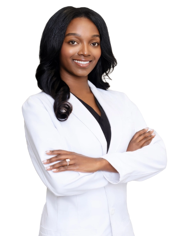 A professional portrait of a Physician Assistant at Vein Treatment Clinic. She is wearing a white medical coat and standing with her arms crossed, representing the expert and compassionate clinical team dedicated to patient care and pain relief.
