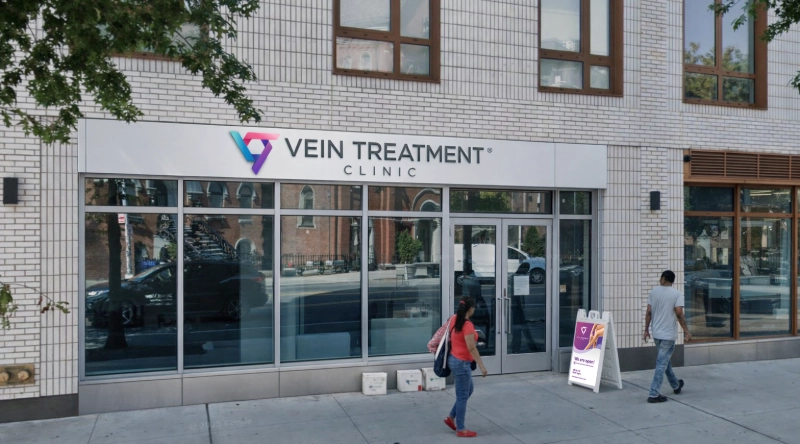 Exterior view Vein Treatment Clinic a modern medical office building under a clear blue sky.