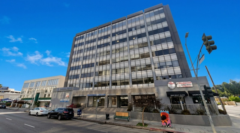 Exterior view Vein Treatment Clinic a modern medical office building under a clear blue sky.