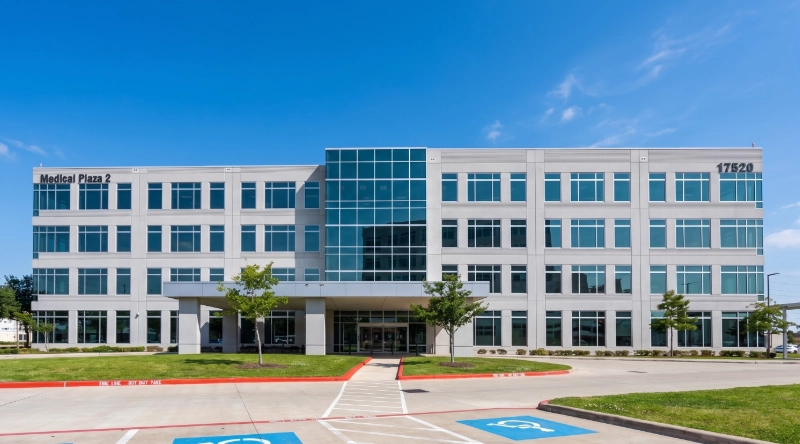 Exterior view Vein Treatment Clinic a modern medical office building under a clear blue sky.