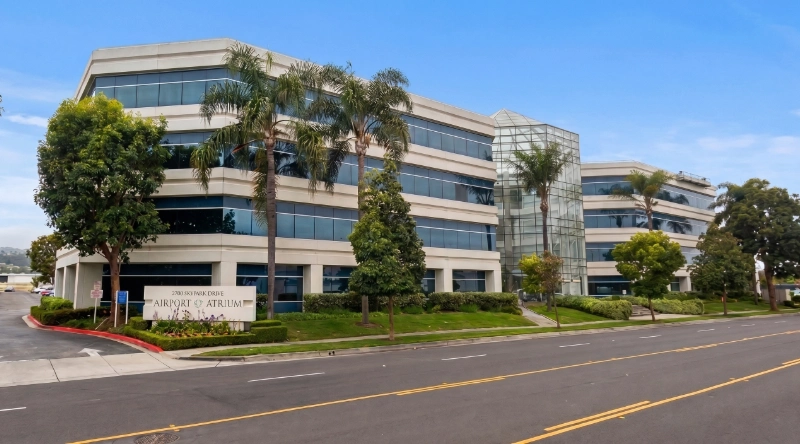 Exterior view Vein Treatment Clinic a modern medical office building under a clear blue sky.