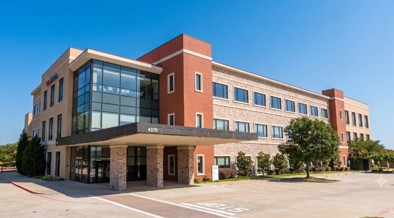Exterior view Vein Treatment Clinic a modern medical office building under a clear blue sky.