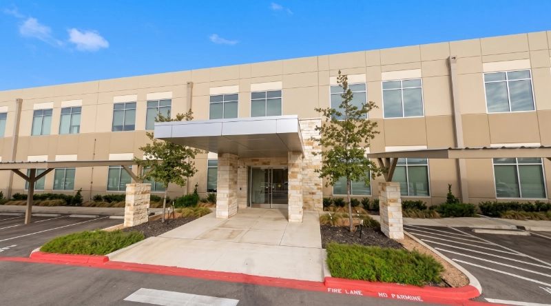 Exterior view Vein Treatment Clinic a modern medical office building under a clear blue sky.
