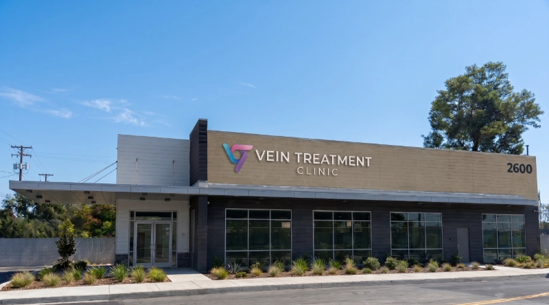 Exterior view Vein Treatment Clinic a modern medical office building under a clear blue sky.