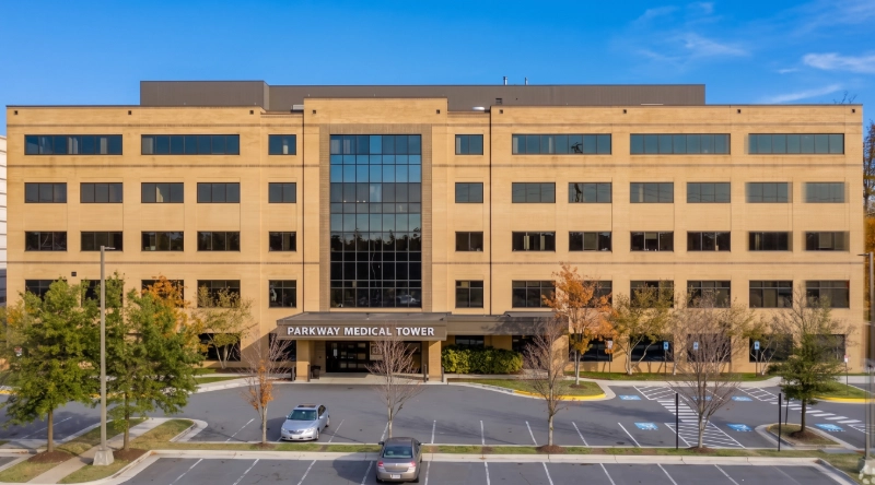 Exterior view of VIP Medical Group clinic in Reston - Virginia, a modern medical office building under a clear blue sky.